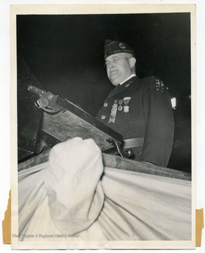 Text on the back reads, "The above photo shows Commander Louis Johnson of the American Legion as he addressed the members of the organization at the Chicago Stadium, Chicago, Illinois, when the convention was opened on October 2nd."