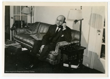 Text on the back reads, "When Assistant Secretary of War, Col. Louis Johnson was famous as hard worker, hard driver. During preparations for important mission to aid India in fighting off Japanese, the telephone in his Washington apartment was seldom silent." Johnson served as the President's personal representative in India in 1942.