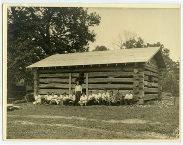 Cabin builders pose in front of building.