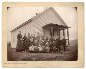 The students of the Bruceton Mills School pose for a group photograph. The tallest young man is thought to be C. T. Kelly, and the girl on his right is thought to be Dessie Feather.