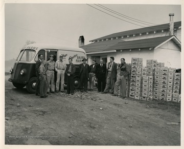 Group of men in front of a dairy truck.