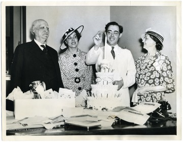 Text on back reads, "Washington, D. C.: U S. Senator-elect Rush D. Holt, of West Virginia, his sister, Jane, and his parents, Dr. and Mrs. Mathew S. Holt, celebrating the young Solon's thirtieth birthday, today (June 19). Holt's parents came from their home in West Virginia to help celebrate his birthday, and also to see him take his seat in the upper branch of our national legislature, as the 'baby' of that body. The Senate elections committee has submitted two reports on his case: a majority report favoring his seating, and a minority report that asks that his election be voided. It is expected that the majority report will be acted upon."