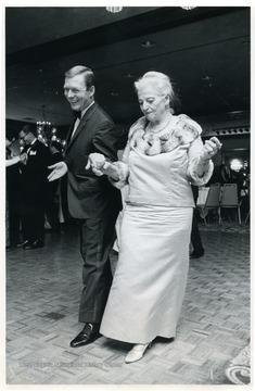 "Miss Pearl Buck dances with Theodore F. Harris, executive director of the Pearl S. Buck Foundation."