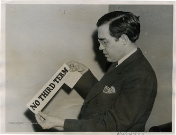 Senator Rush Holt of West Virginia holds post card and sticker which he received, reading "No Third Term." These were chain mail intended to urge receivers to send a card to the White House protesting against a third term.