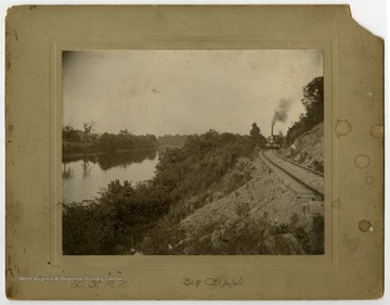 Two men are standing by the tracks of the Little Kanawha Railroad, which follows the Little Kanawha River through Wirt and Wood Counties. 