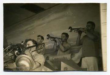 Band plays at Waikiki Breakers Club with "Commandos" music stands.