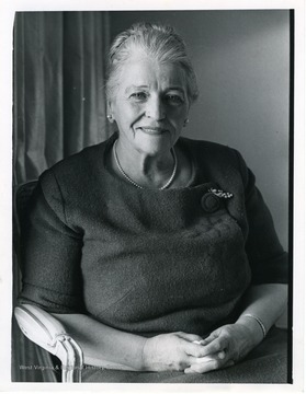 The back of the photo includes a newspaper caption that reads:Pearl S. Buck writes lovingly of "The Good Earth," saying it is the key to human life and world peace.