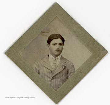 Small portrait of a man in a striped suit.The back of the photo reads:"il mio cognato l'aro dello mio cuoreGennaro di Spenna.A. Lupant"