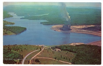Text on the back reads, "Stony River Dam and $150,000,000 power plant of the Virginia Electric and Power Company near Mt. Storm, West Virginia. This new 1200 acre lake is located in some of the most rugged country in West Virginia. In the distance is the old Stony River Dam. The highway shown is W. Va. Route 93 which crosses the dam and follows Beaver Creek to Davis, West Virginia. This area is approximately 25 miles from Oakland."