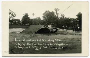 Text reads, "Scene of south end of Petersburg, W. Va. as raging waters carry away slaughterhouse in foreground. Photo by Addison. Flood of June 17 1949."
