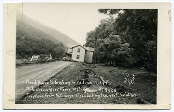Text reads, "Flood scene, Petersburg, W. Va. June 17, 1949. Photo shows Ours home resting on Rt. 4 and 28. Travellers from N. Y. were stranded on this roof for 15 hours."