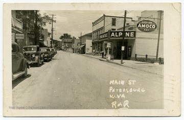 This view of Petersburg's Main Street features the Alpine Theater, which is no longer open, and a sign advertising Amoco American Gas. 