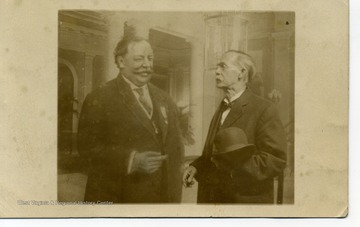 President Taft appears to be a painting that Mr. Kelley is standing in front of. Back of postcard reads: "Mr N. Stealey. Dear Sir, I come through All O.K. I want to have a big time with Bill for a day or two. You can keep that quiet. Yours truly, I. M. Kelley."