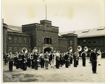 The ROTC band presents in front of the WVU Armory building.