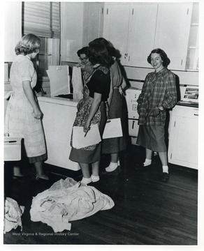 Women operating a laundry machine at Jackson's Mill. 