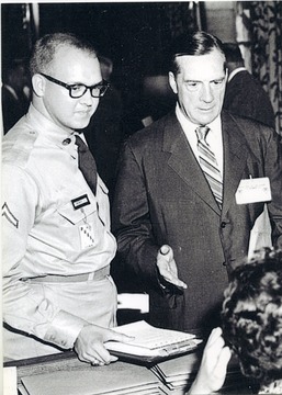 Rene A. Henry (left) assists Hall of Fame football coach Earl Blaik (right) register for the 1st President's Conference on Physical Fitness & Sports.