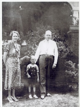 Rene Henry Jr. with parents Lillian and Rene Henry in front of their home.