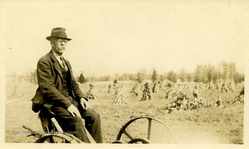 Charles Skidmore Harper in front of his garden.