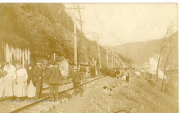 Crowds gathering on train tracks to view the remains of the Monongah Mines after the explosion.