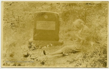 A picture of Maggie Hatfield at the grave of her husband, Elliot Hatfield.