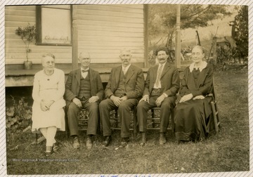 Portrait of five people in front of a house. From right to left: Laura, Horace Garrey(sp?) Jenkins, Scott Jenkins, George Jenkins. 